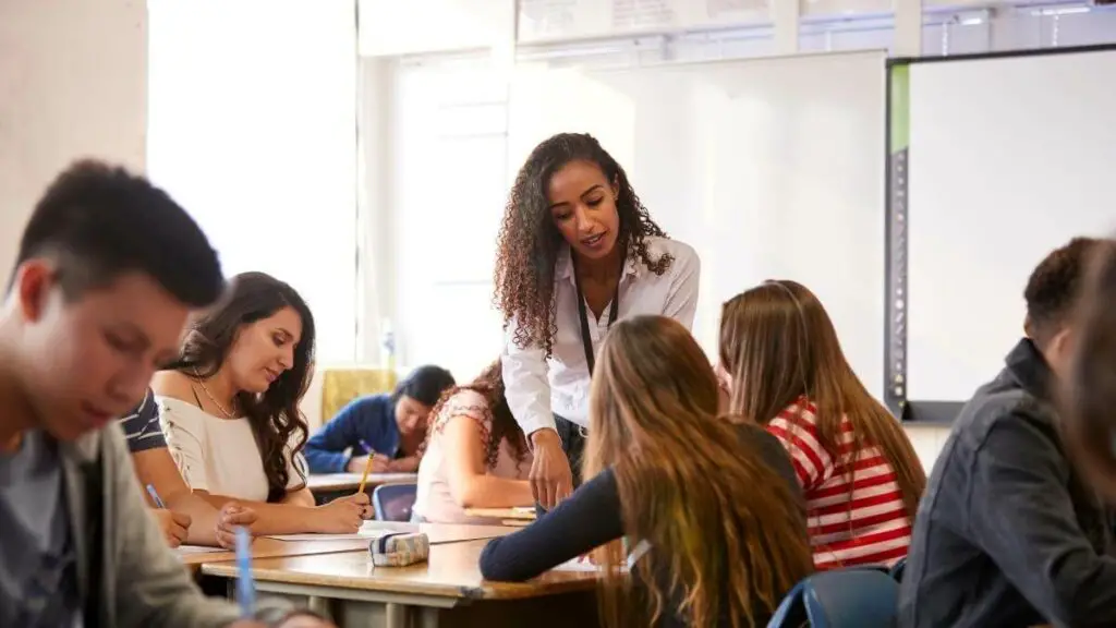 high-school-teacher-helping-students